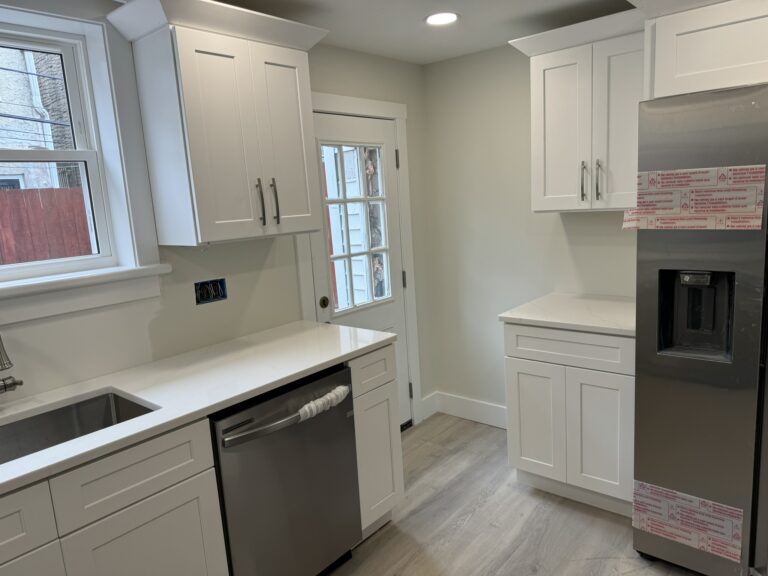 Completed kitchen with stainless appliances and quartz landing counter