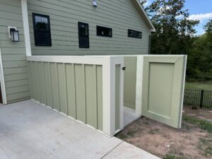 Custom board-and-batten equipment enclosure matching the home's siding