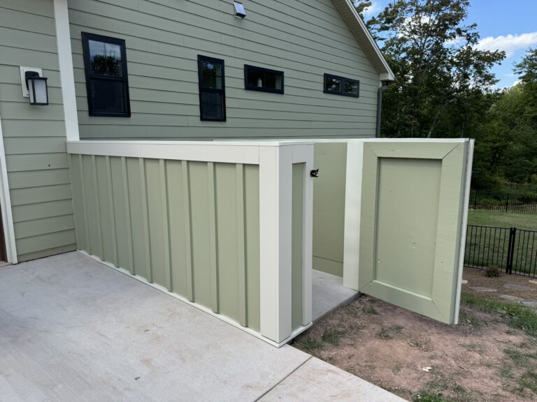 Custom board-and-batten equipment enclosure matching the home's siding