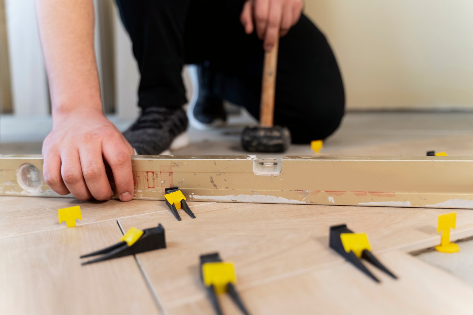 Contractor installing tile flooring during a Lancaster County home remodel